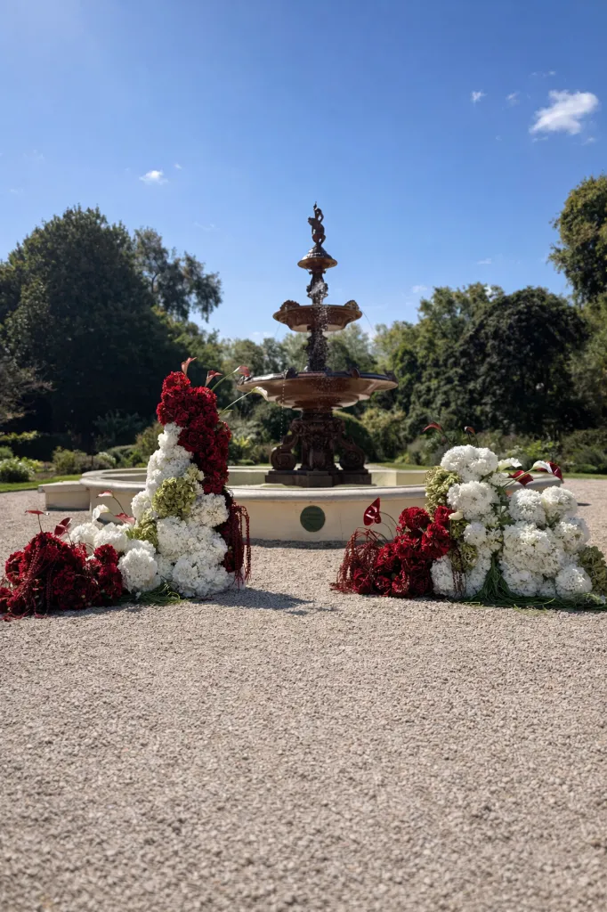 Garden fountain with floral arrangements.webp
