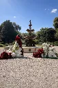 Garden fountain with floral arrangements.webp
